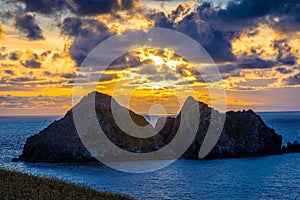 Gull rocks at sunset in Hollywell Bay in Cornwall