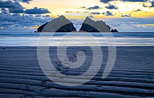 Gull rocks at sunset in Hollywell Bay in Cornwall