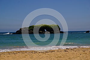 gulls nesting rock near a beach in spain photo