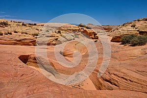 Gully in the Nevada desert surrounded by the colorful pink lined rocks