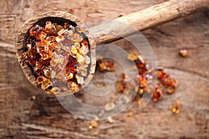 Gum arabic, also known as acacia gum - in old wooden spoon