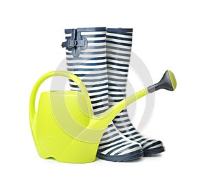 Gumboots with watering can for gardening on white background