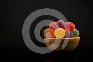 Gumdrops, Colorful Fruit Sugarcoated Marmalade balls in Wooden Bowl. Traditional Scandinavian Christmas Candy