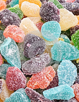 Gumdrops jelly beans candies in the form of raspberries and blackberries in a box for sale in a market during food festival. Kids