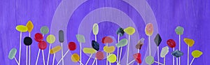 gummy candies, colorful jelly fruit gums, sweet food, close up, panoramic format on purple background