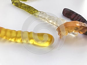 Gummy worms. gelatin worms, high-calorie and delicious desserts. delicious candies on a white matte background. bright worms.