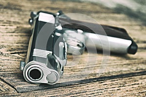 Gun Barrel, 1911 Model, Semi-automatic handgun on wooden background.