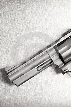 Gun on brushed metal background