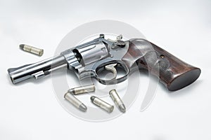 Gun and bullet on white background