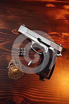 Gun, bullets and police badge