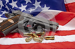 Gun and bullets , Semi automatic pistol handguns with ammunitions on an american flag background