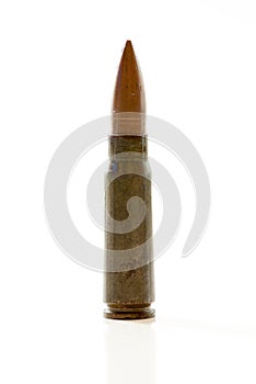 Gun cartridge with bullet and case on white background with reflexion