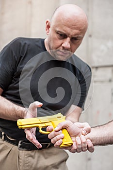 Gun Disarm. Self defense techniques against a gun point.