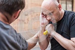 Gun Disarm. Self defense techniques against a gun point.