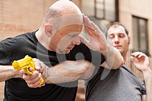 Gun Disarm. Self defense techniques against a gun point.