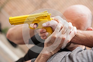 Gun Disarm. Self defense techniques against a gun point.