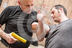 Gun Disarm. Self defense techniques against a gun point.