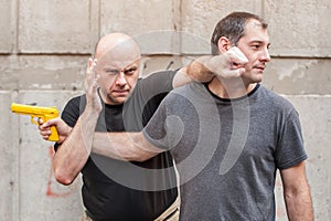 Gun Disarm. Self defense techniques against a gun point. photo