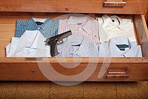 Gun hidden in a drawer full of shirt