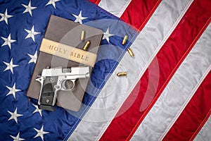 Gun on Holy Bible with American Flag