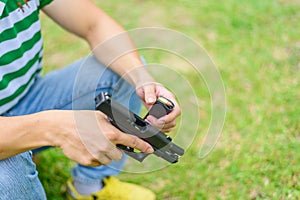 Gun man hand on green background