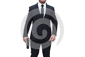 A gun man wearing a black suit is holding a gun in a stalwart pose on a white background. Concept for assassin, murder,