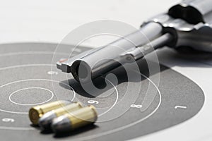 gun with 9mm bullets on the target