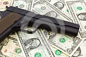 Gun on money background.