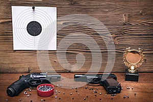 Gun and paper target. Shooting practice. Shooting range.