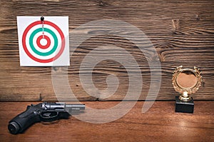 Gun and paper target. Shooting practice. Shooting range.