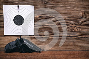 Gun and paper target. Shooting practice. Shooting range.