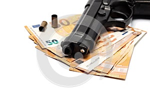 Gun pistol and money euros on white background.