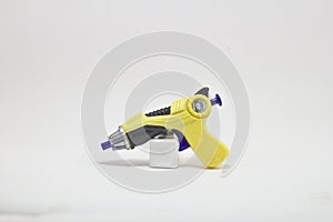 Gun plastic toy yellow on white background.