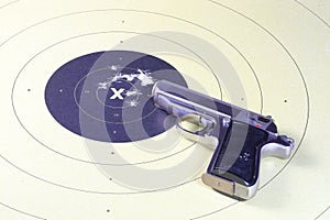 Gun and shooting target With Bullet Holes. Classic Paper Shooting Target.