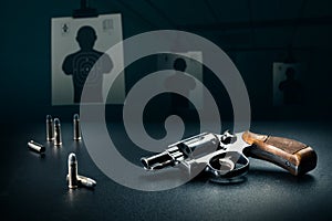 Gun sitting on a table at a shooting range / dramatic lighting