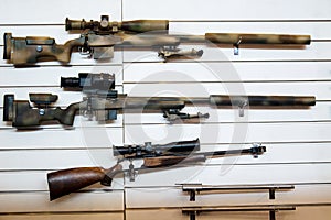 Gun wall rack with sniper rifles