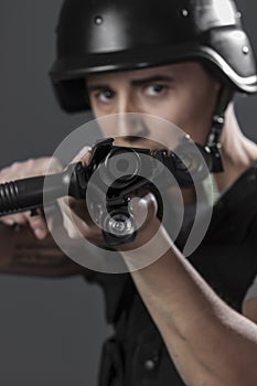 Gunfire, paintball sport player wearing protective helmet aiming photo