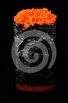 Gunkan Maki Sushi with red flying fish roe on black background