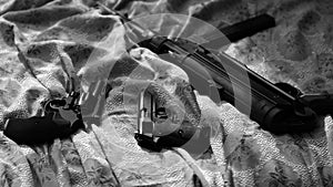 Guns On Bed Sheet. Film Noir Style. Revolver, Pistol, Machine Gun. photo