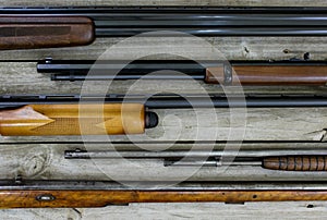 Guns hanging on rustic wooden wall