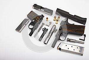Guns , Part of Semi automatic pistol handguns with .45 bullets on white background , The same of single action operating system