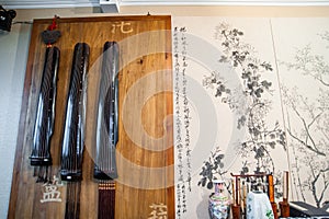 Guqin on the wall in the room