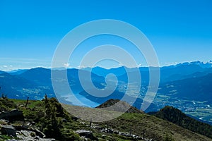 Gurglitzen - Idyllic hiking trail on alpine meadow with scenic view of lake Millstatt seen from mountain peak Boese Nase