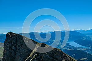 Gurglitzen - Idyllic hiking trail on alpine meadow with scenic view of lake Millstatt seen from mountain peak Boese Nase