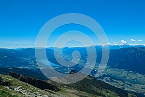 Gurglitzen - Idyllic hiking trail on alpine meadow with scenic view of lake Millstatt seen from mountain peak Boese Nase