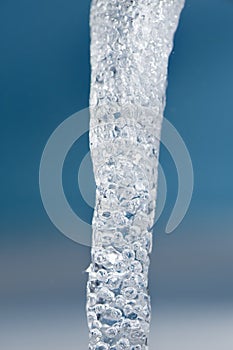 Gush of water on blue background