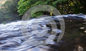 Gushing out a lot of water down a steep vertical cliff at Yudaki Falls in Nikko,Tochigi,Japan.