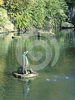 Gushing seal sculpture on a park pond