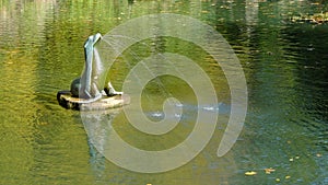 Gushing seal sculpture on a park pond