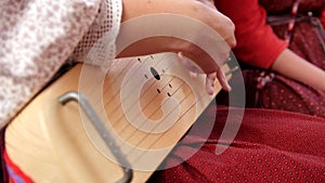 Gusli - woman in Russian folk costume playing vintage musical instrument